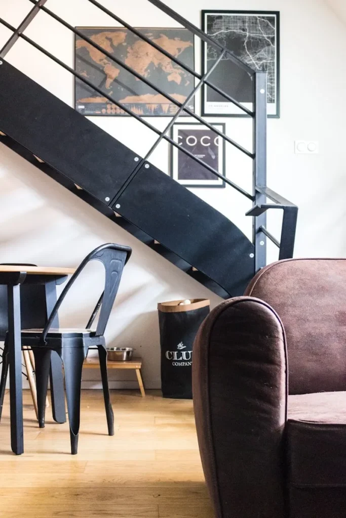 a living room filled with furniture and a stair case